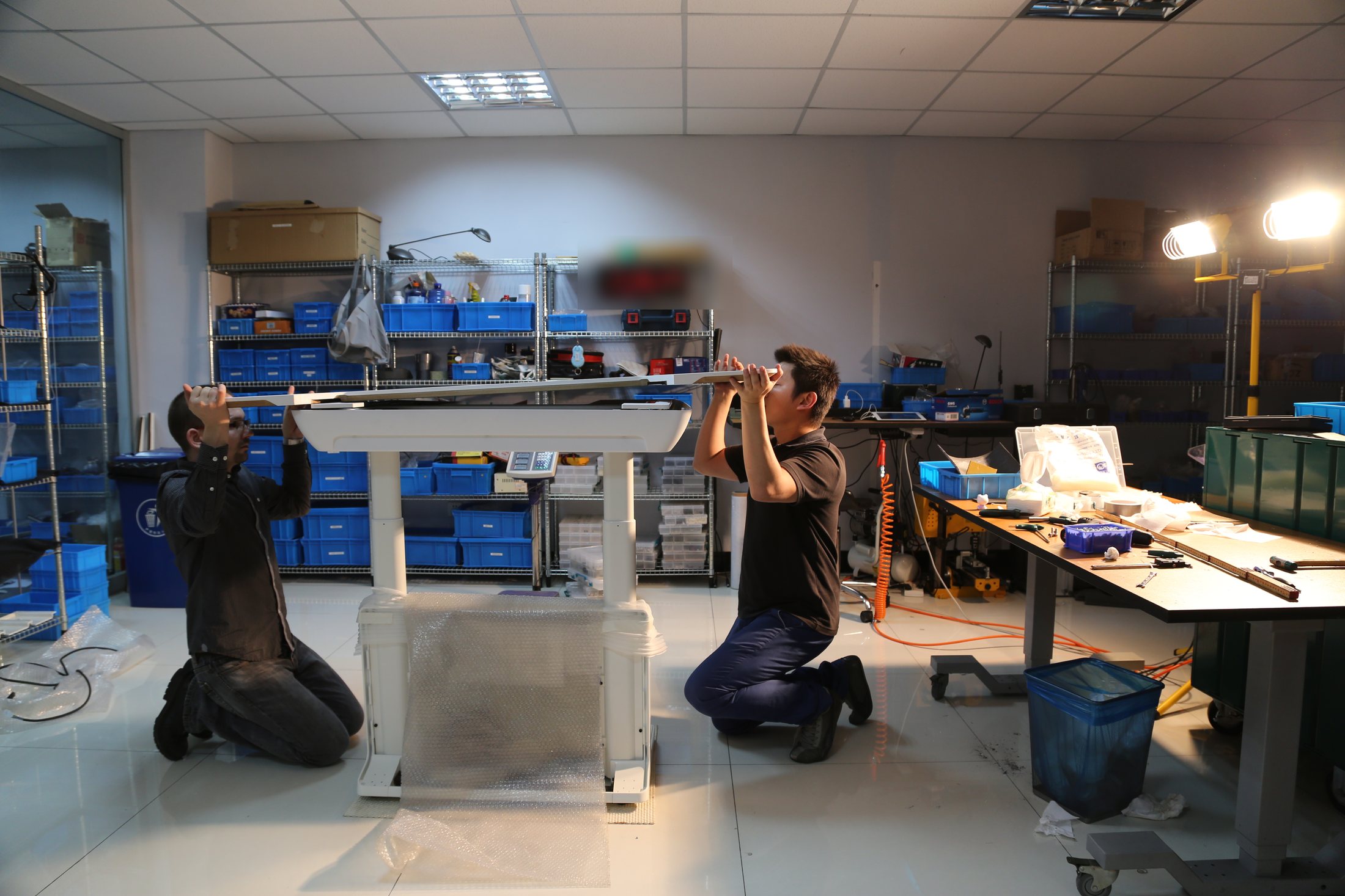 Engineering team aligning a Herman Miller T2 development prototype in the workshop
